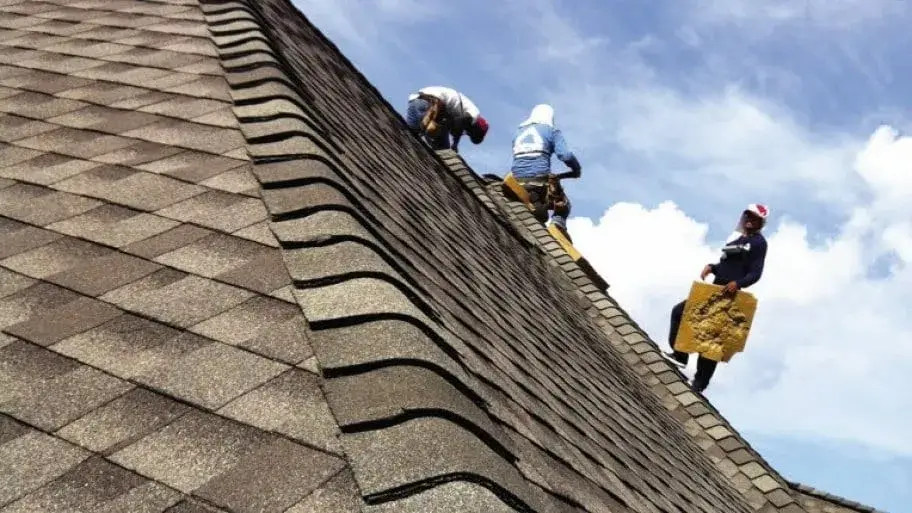 Roofing contractors repairing hail damage.